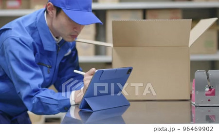 Supervisor organizing boxes on racks, carrying packages before